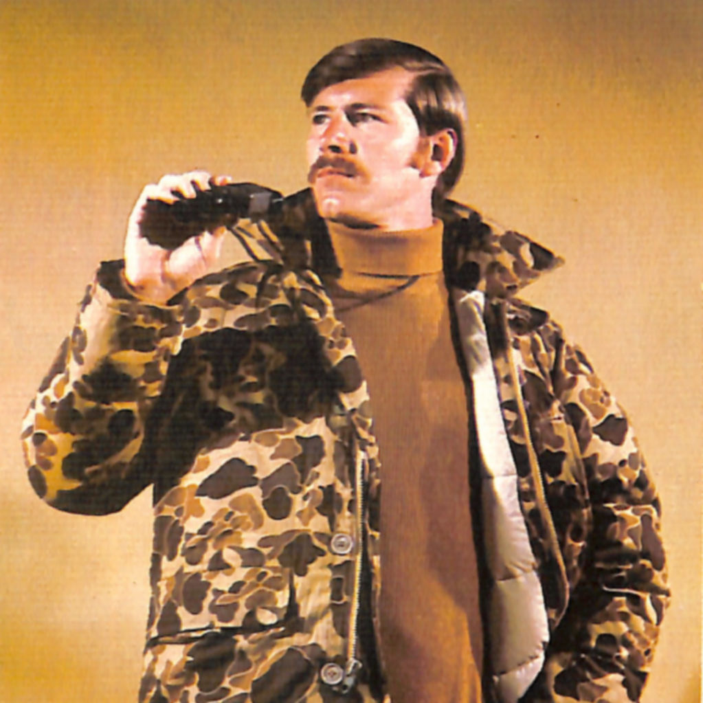 An image from the 1971 Orvis catalog of a man wearing a camo-patterned coat and turtleneck